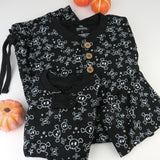 Go to slide 6, Halloween Matching Family Pajamas, Tossed Skulls Black